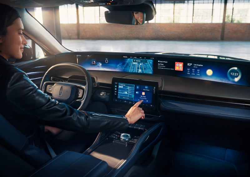 The driver of a 2025 Lincoln Nautilus® SUV interacts with the center touchscreen. | Wallace Lincoln in Fort Pierce FL